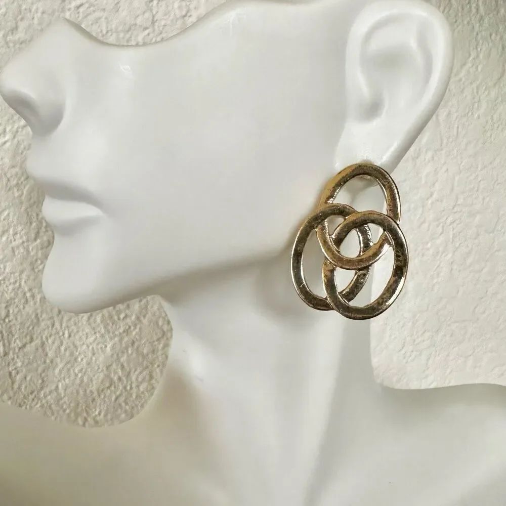 Gold tone intertwined circle post earrings